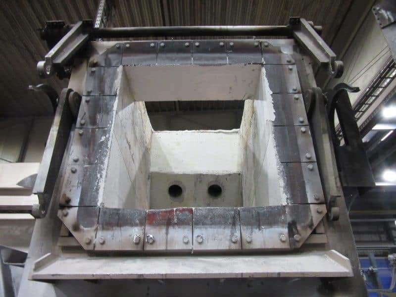 Vorgefertigter Brennerumlauf in der Werkstatt, hängend am Kran, mit zwei Brenneröffnungen