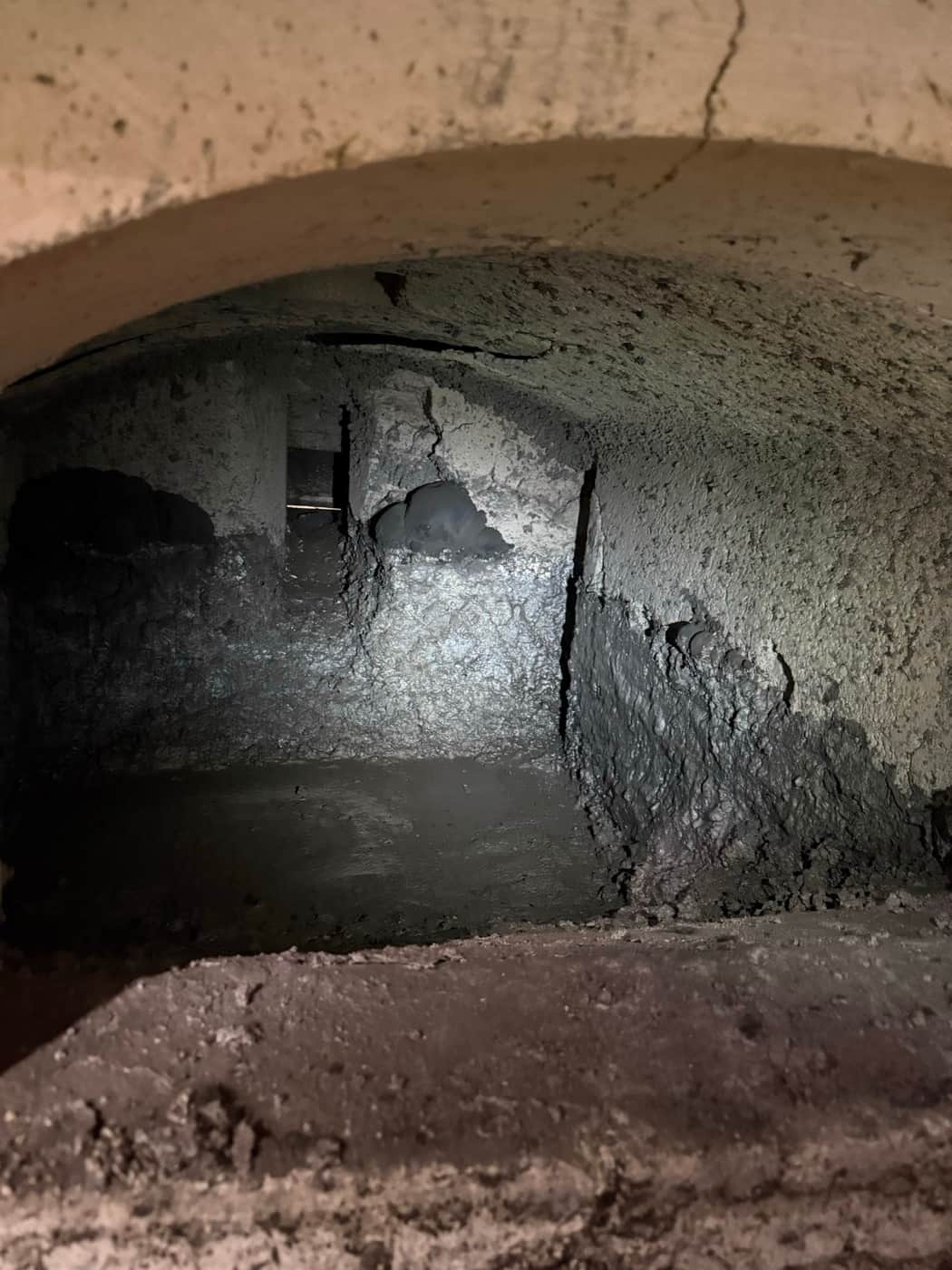 Fissure dans la voûte d'une chambre de fusion, avec des accrétions sur la paroi latérale