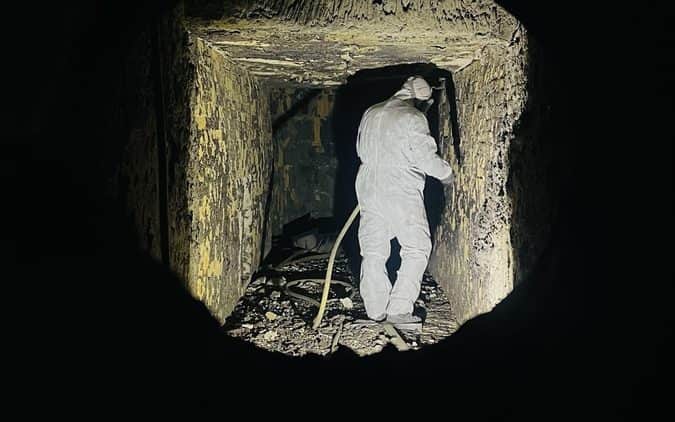 Entry into a confined furnace chamber with lighting and a standby attendant
